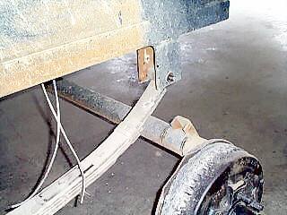 Axle positioned to mount under leaf spring
